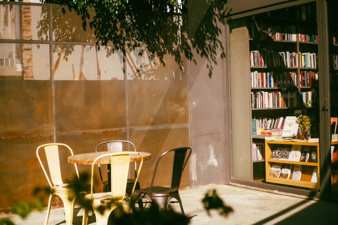 Brazilian man reading a book at a small cafe table